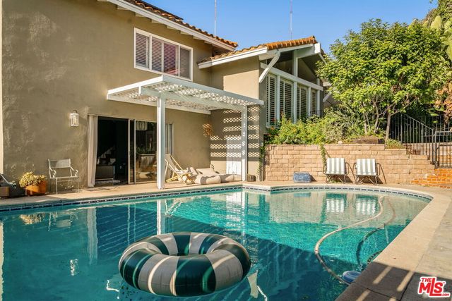 a balcony with table and chairs