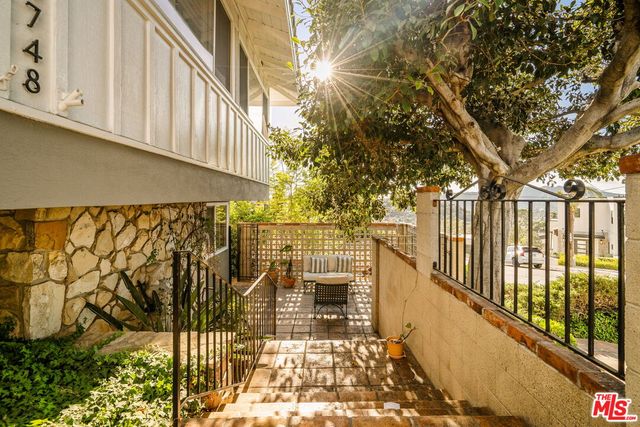 a view of a balcony with wooden fence