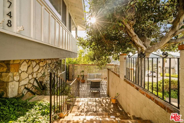a view of a balcony with wooden fence