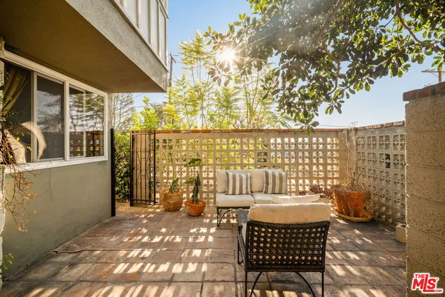 a living room with furniture large windows and a flat screen tv