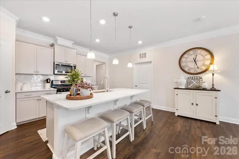 a kitchen with stainless steel appliances granite countertop a sink a stove and a microwave