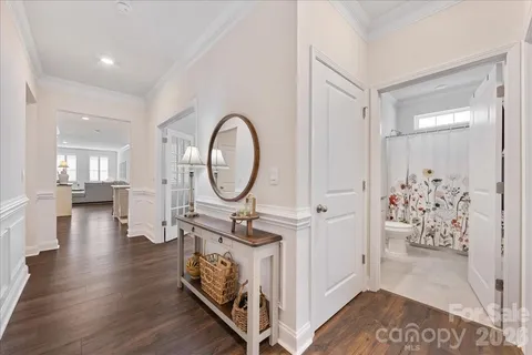 a bedroom with a bed and painting on the wall