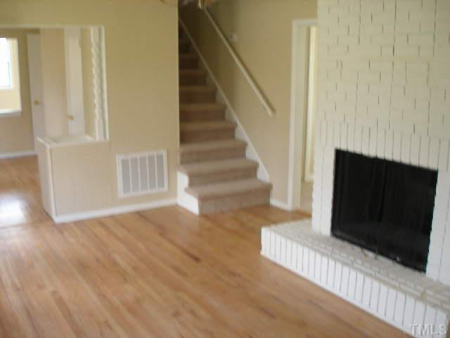 2108 Atkins Drive Raleigh, NC 27610 - Photo 3 of 11 a view of a livingroom with wooden floor and staircase