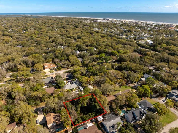an aerial view of residential houses with city view