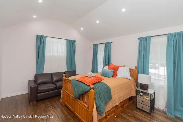 a bedroom with a bed and a couch