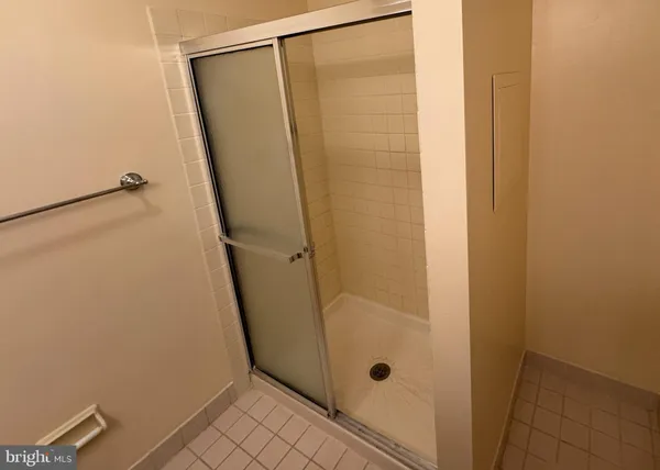 a bathroom with a glass shower door
