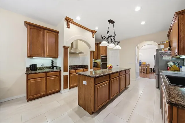 a kitchen with stainless steel appliances granite countertop a sink and cabinets