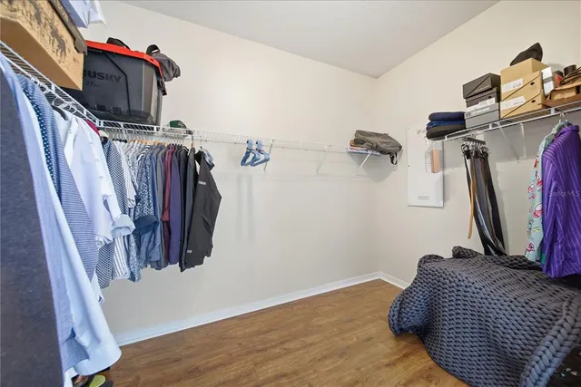 a view of walk in closet with clothes and shoes