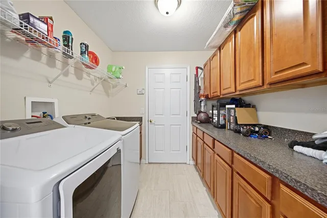a kitchen with a sink a stove and cabinets