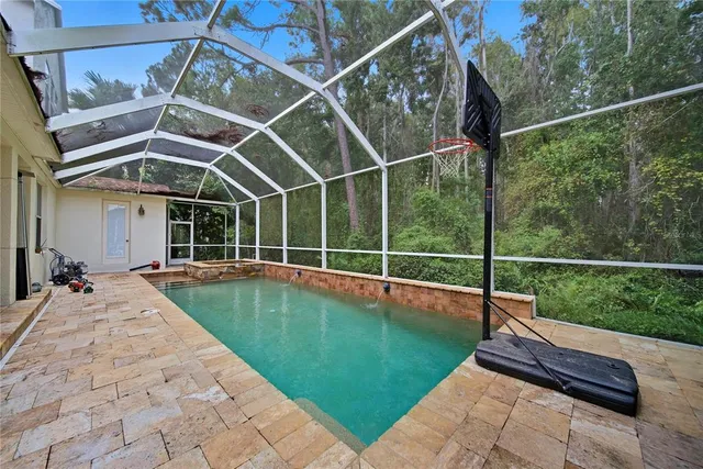 a view of a backyard with swimming pool