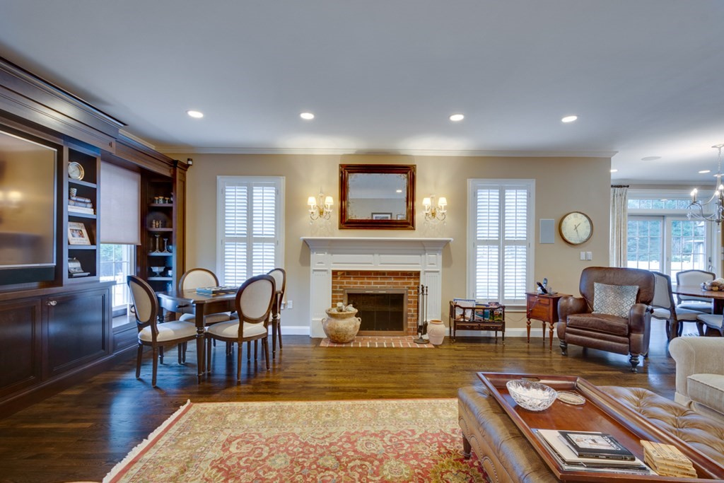 24 Fletcher Road Needham, MA 02492 - Photo 11 of 29 a living room with furniture a fireplace and a flat screen tv