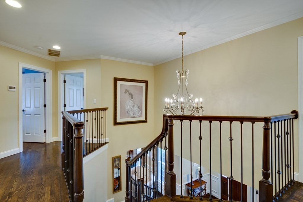 24 Fletcher Road Needham, MA 02492 - Photo 13 of 29 a view of a hallway with wooden floor and stairs