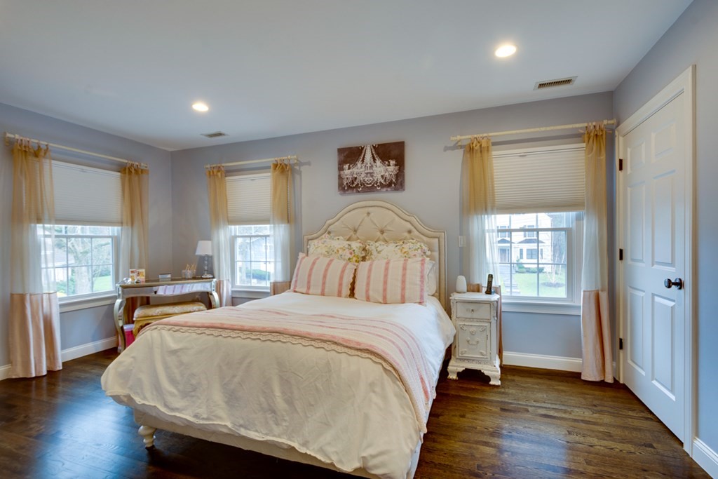24 Fletcher Road Needham, MA 02492 - Photo 15 of 29 a bedroom with a large bed and wooden floor