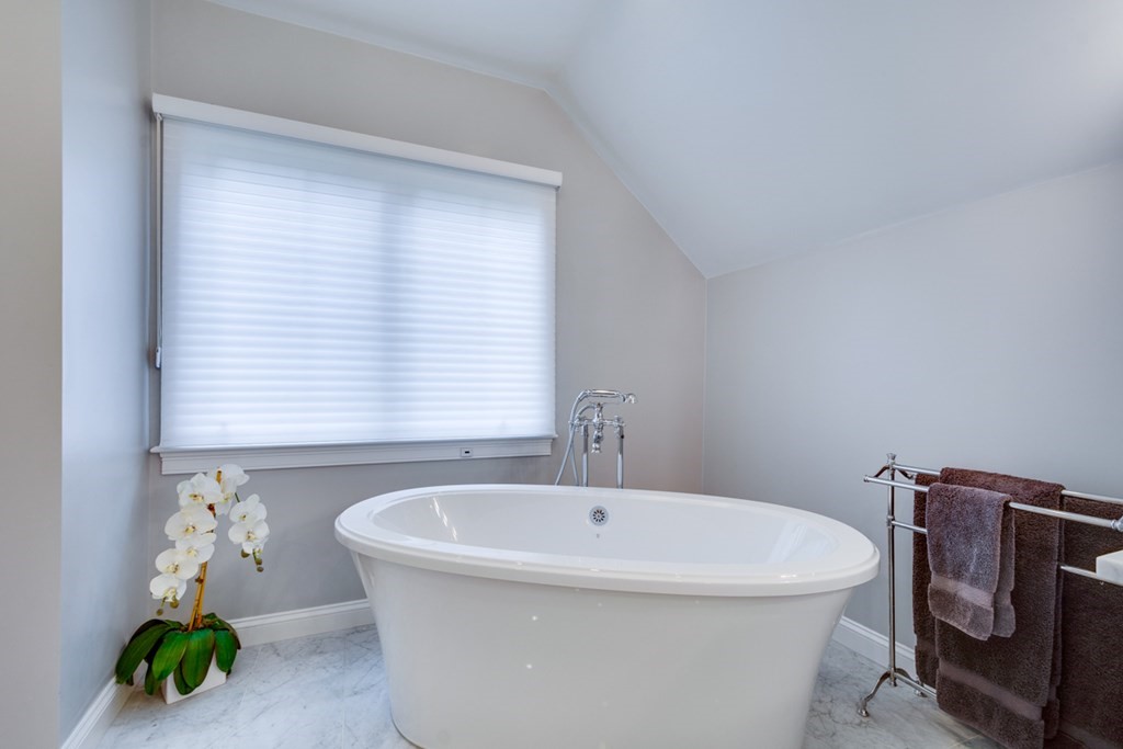 24 Fletcher Road Needham, MA 02492 - Photo 24 of 29 a white bath tub sitting next to a window