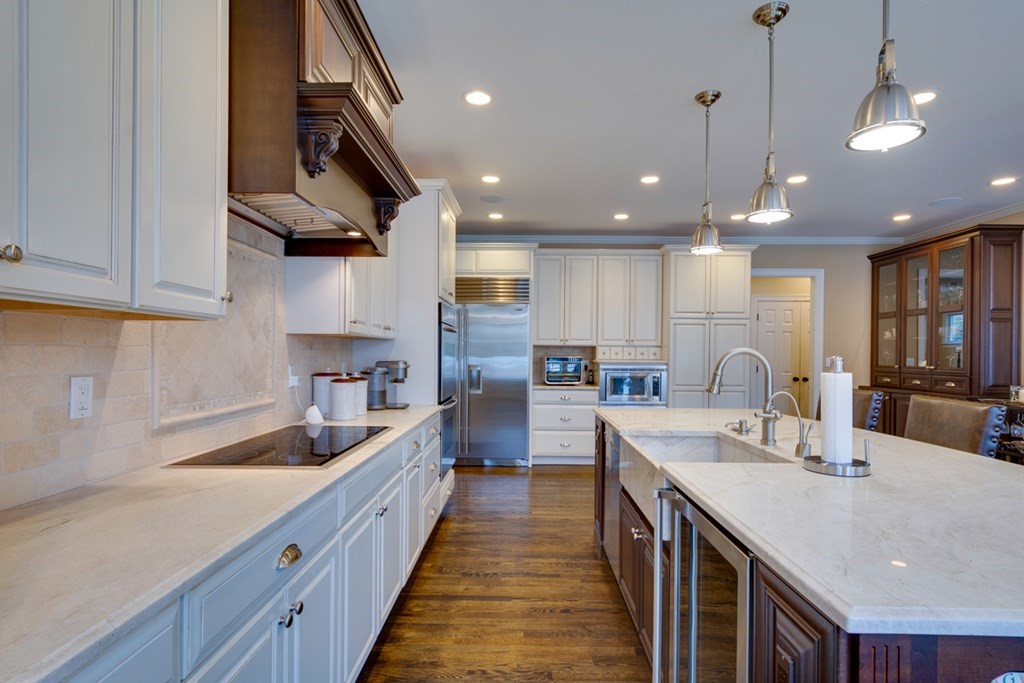 24 Fletcher Road Needham, MA 02492 - Photo 7 of 29 a large kitchen with kitchen island a sink a counter space and stainless steel appliances