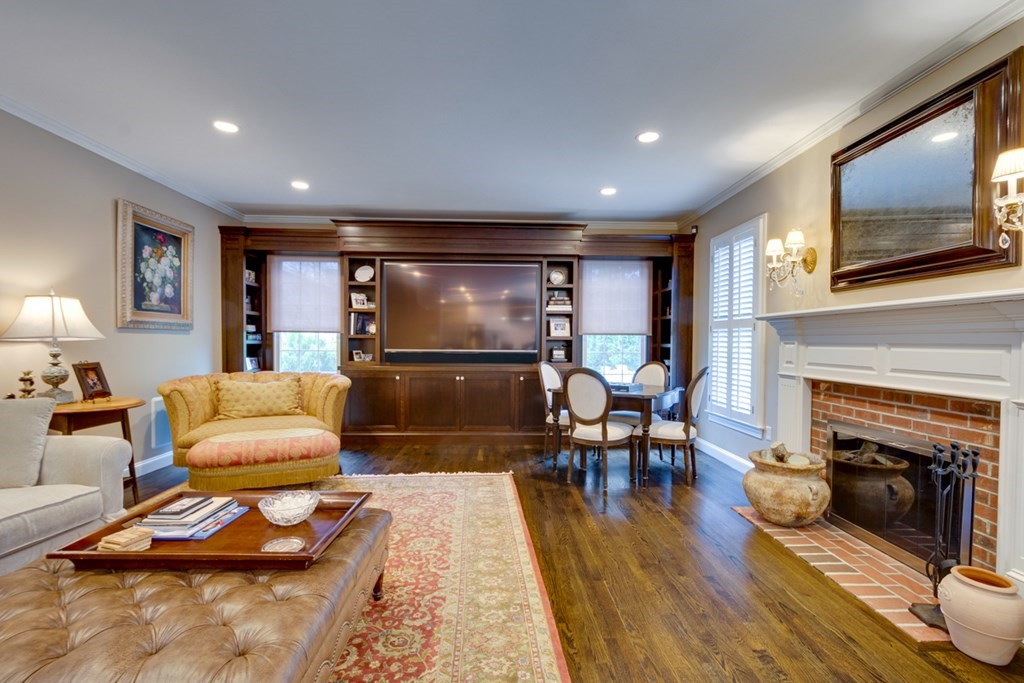 24 Fletcher Road Needham, MA 02492 - Photo 10 of 29 a living room with furniture and a fireplace