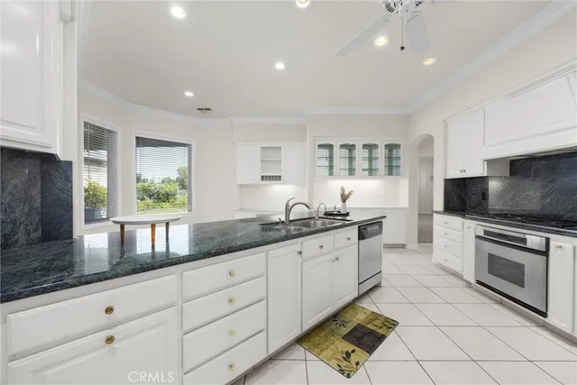 an empty room with fan and windows