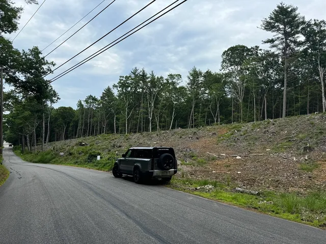 a car parked in front of a house and trees