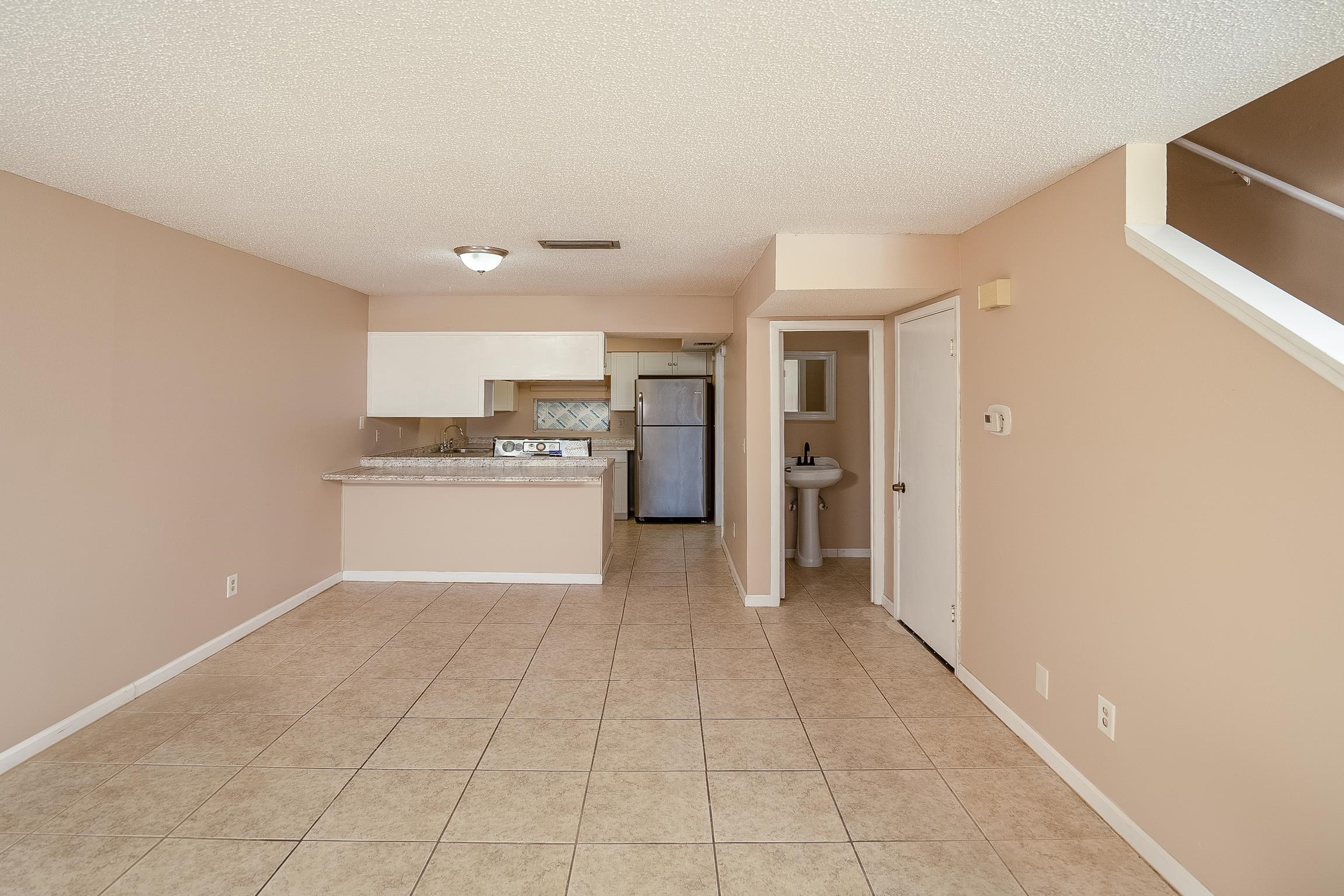 123 Rio Del Mar Street, Unit B St. Augustine, FL 32080 - Photo 16 of 51 a view of a kitchen with a sink and a refrigerator