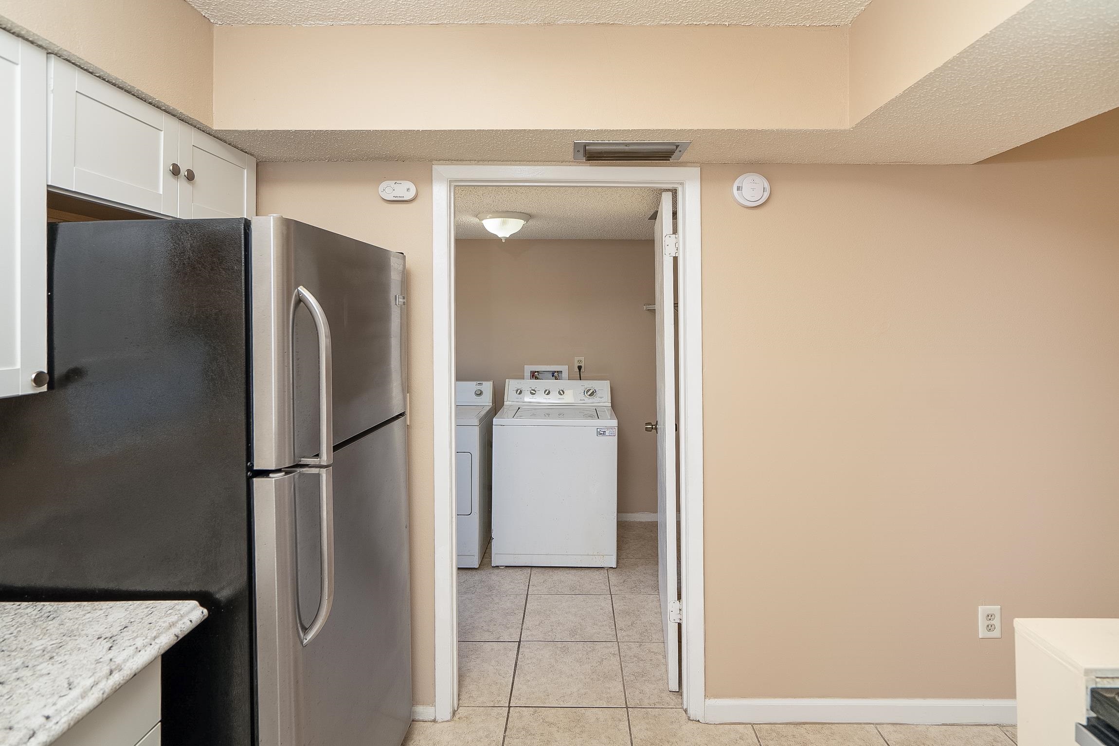 123 Rio Del Mar Street, Unit B St. Augustine, FL 32080 - Photo 24 of 51 a walk in closet and a refrigerator in a kitchen