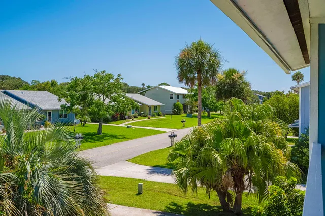 a view of a garden with a building in the background