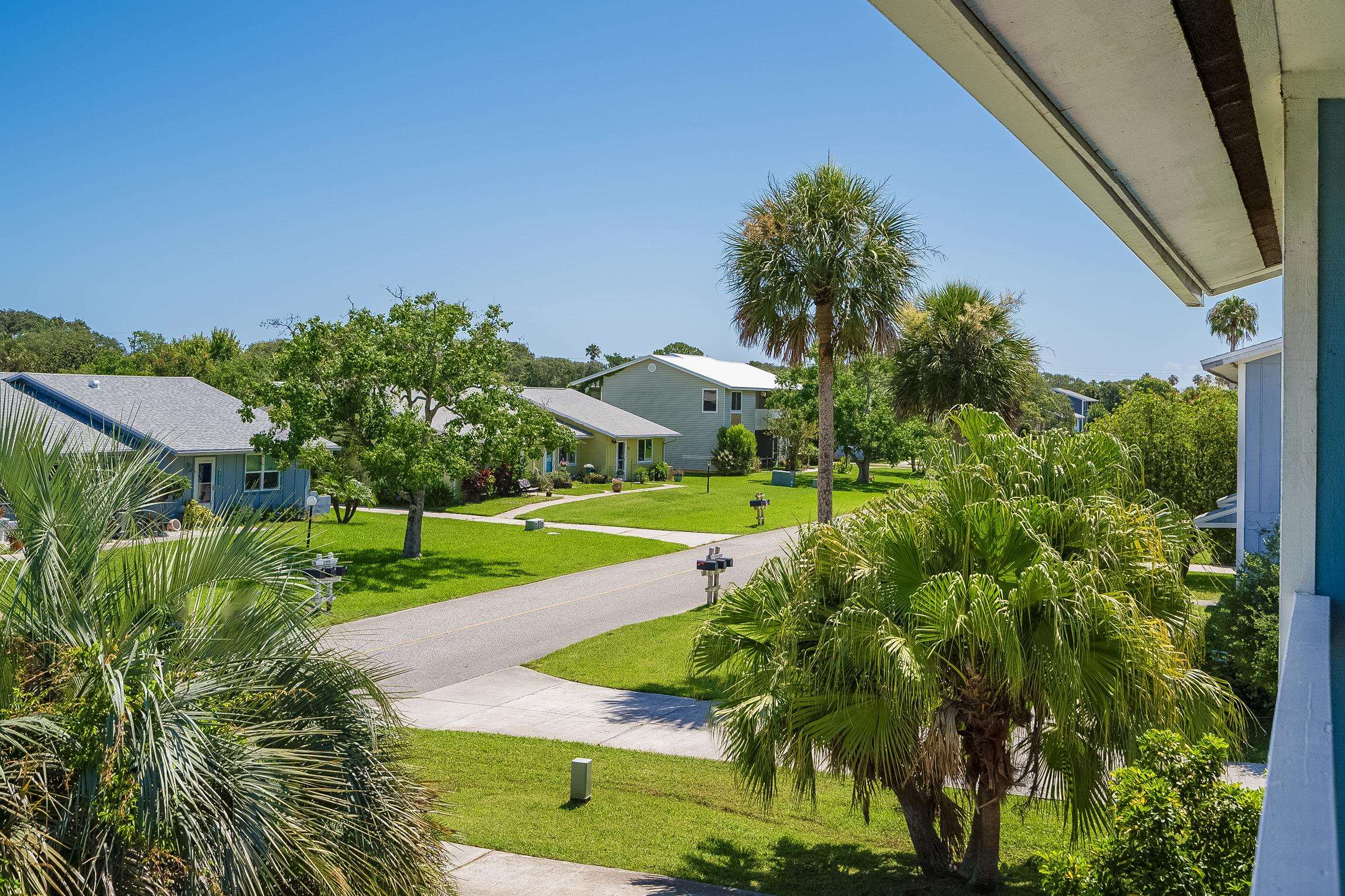 123 Rio Del Mar Street, Unit B St. Augustine, FL 32080 - Photo 36 of 51 a view of a garden with a building in the background