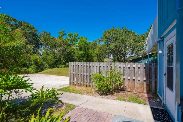 a view of a garden with wooden fence