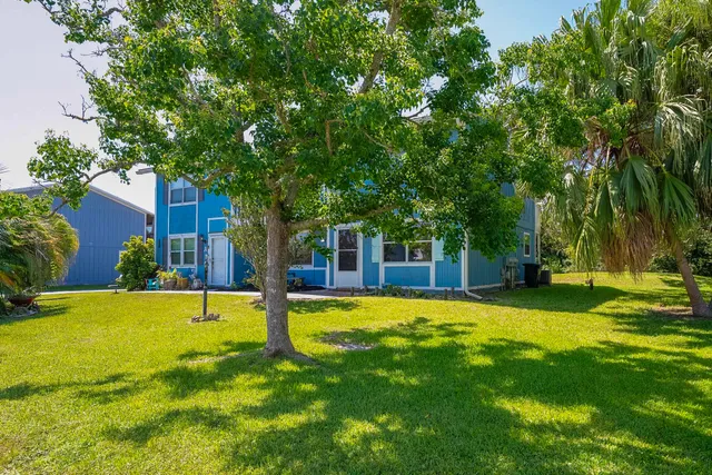 a view of a house with swimming pool and sitting area
