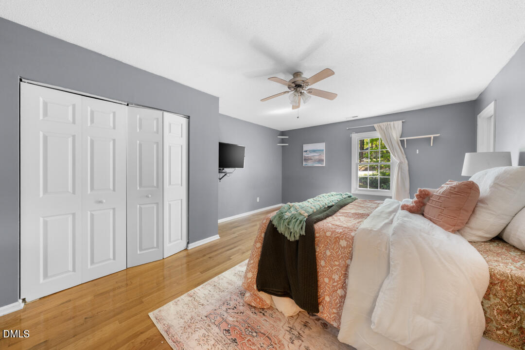 122 Stedwick Place Durham, NC 27712 - Photo 24 of 39 a bed room with a bed a dresser and a window