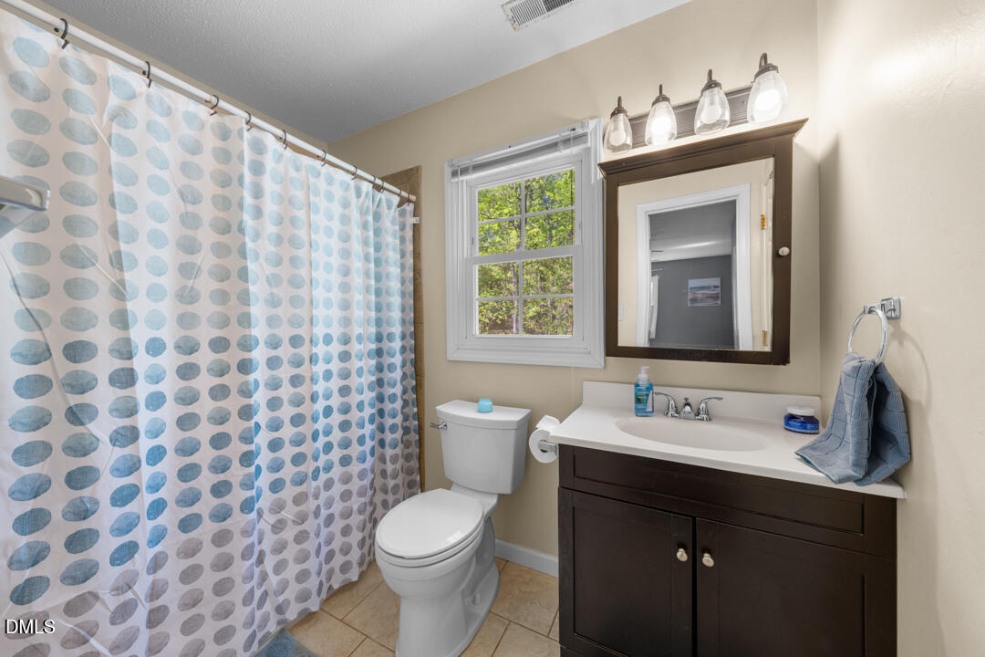 122 Stedwick Place Durham, NC 27712 - Photo 26 of 39 a bathroom with a sink and a mirror
