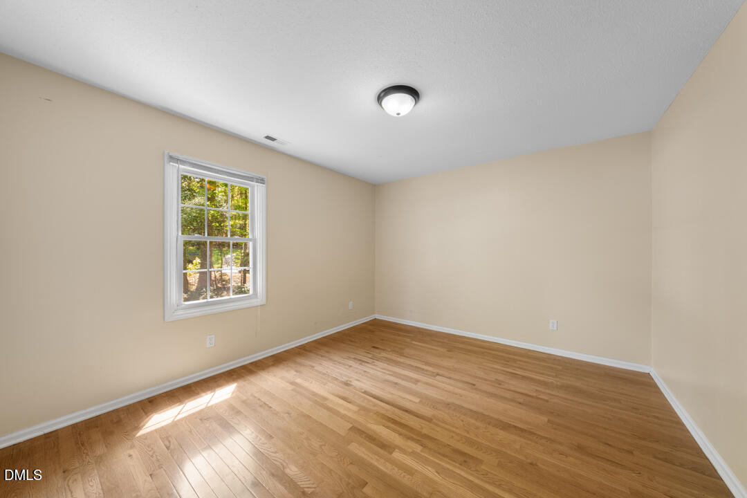 122 Stedwick Place Durham, NC 27712 - Photo 30 of 39 an empty room with wooden floor and windows