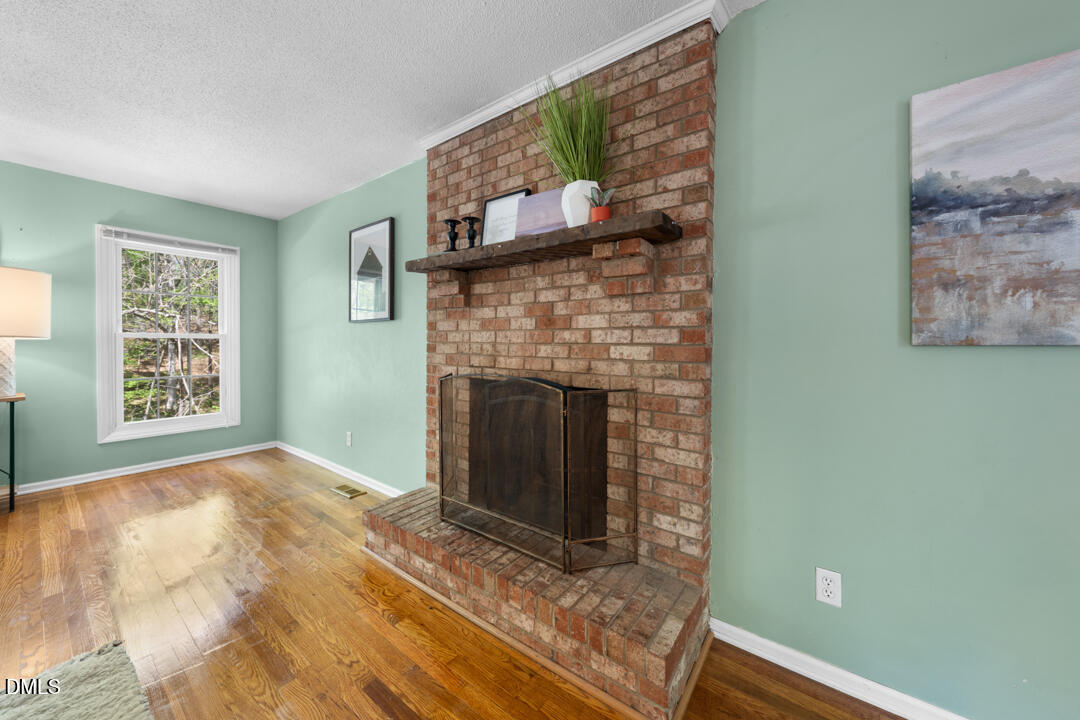 122 Stedwick Place Durham, NC 27712 - Photo 7 of 39 a view of empty room with window and fireplace