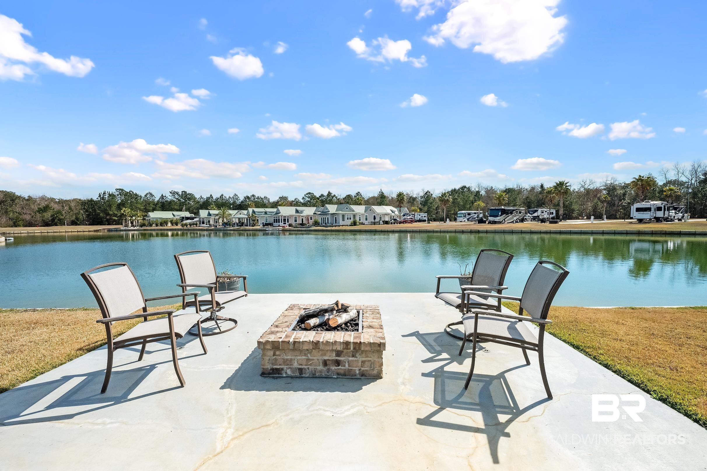 11996 Raptor Court Elberta, AL 36530 - Photo 11 of 45 View of patio / terrace featuring an outdoor fire pit, a water view, and a residential view
