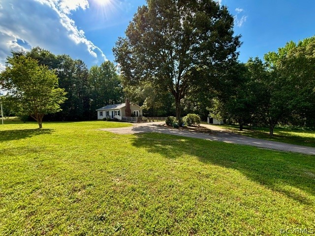 1217 Windyknight Road Montpelier, VA 23192 - Photo 2 of 11 a view of swimming pool with lawn chairs and large trees