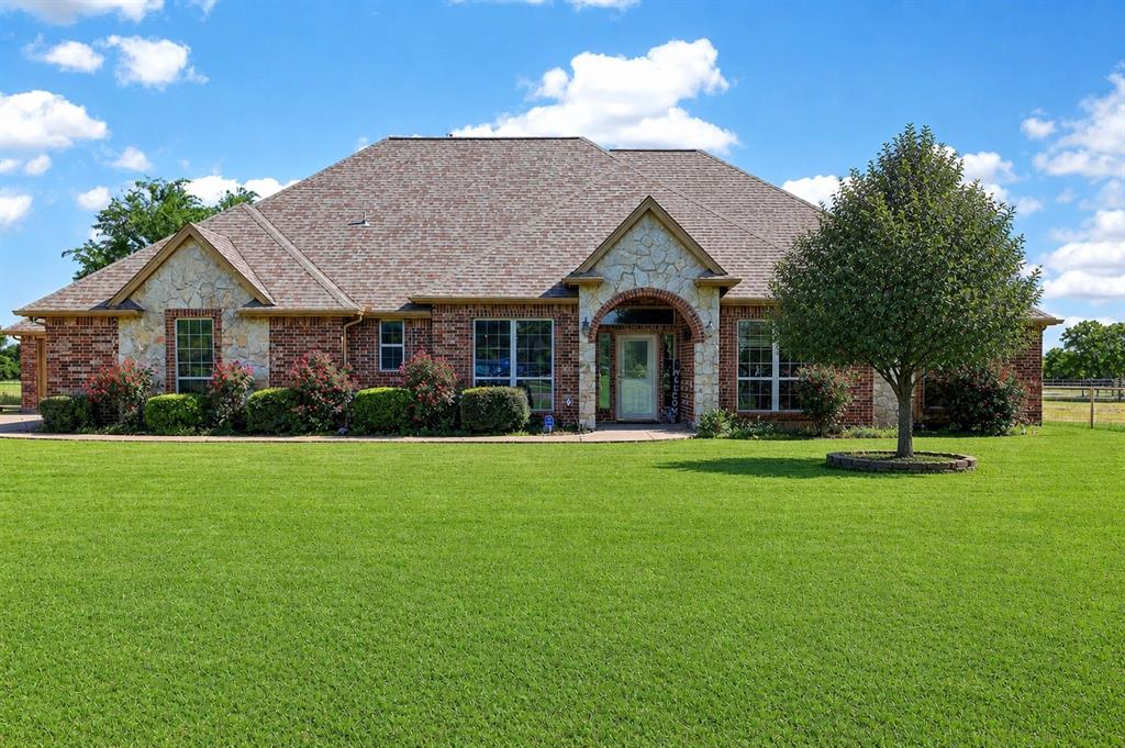1035 Highland Road Cleburne, TX 76033 - Photo 1 of 36 a front view of a house with a yard