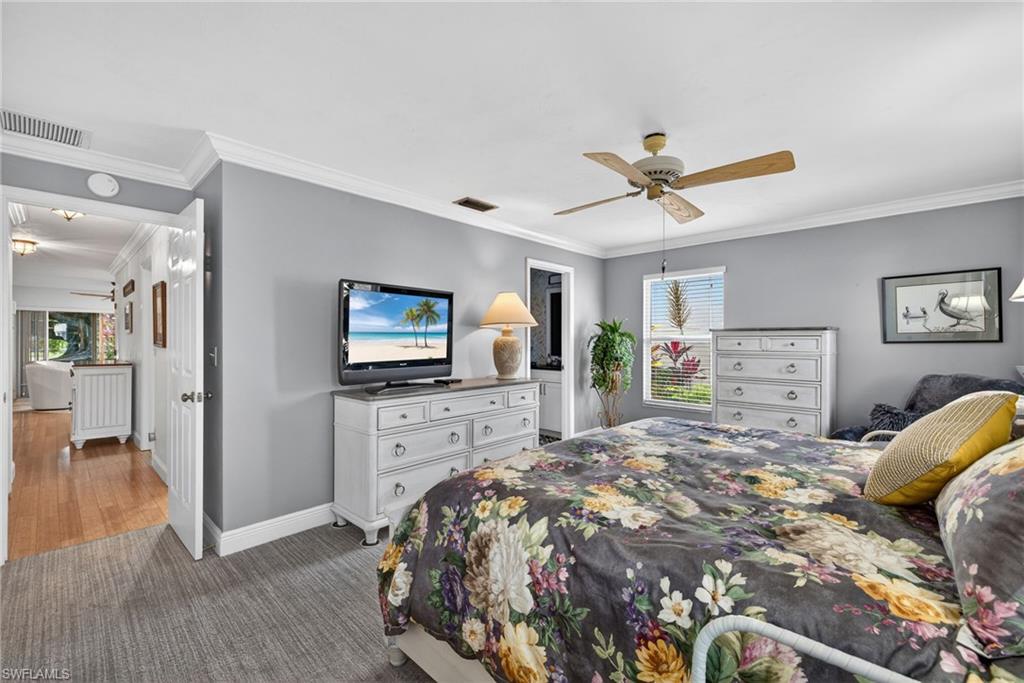 314 Reynolds Court Naples, FL 34112 - Photo 14 of 30 a bedroom with a bed and a flat screen tv