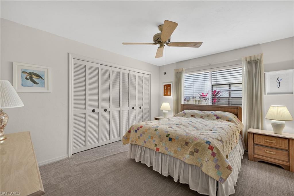 314 Reynolds Court Naples, FL 34112 - Photo 17 of 30 a bed room with a bed window and a walk in closet