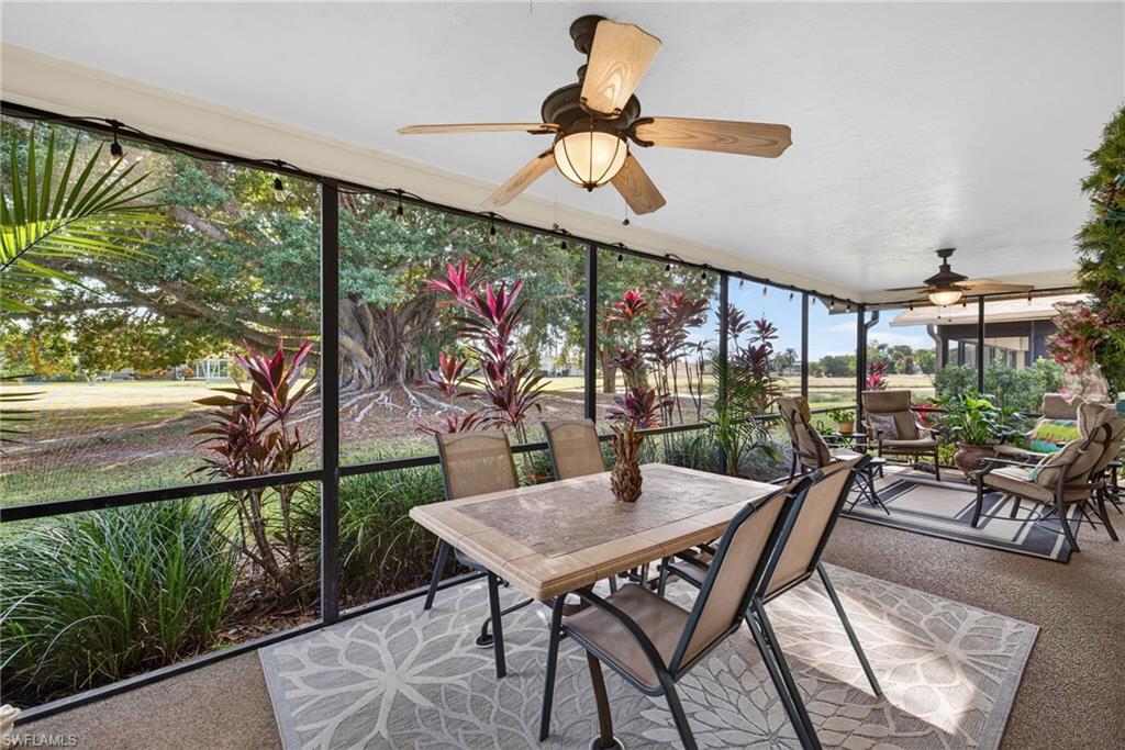 314 Reynolds Court Naples, FL 34112 - Photo 20 of 30 a view of a patio with a table chairs and a floor to ceiling window
