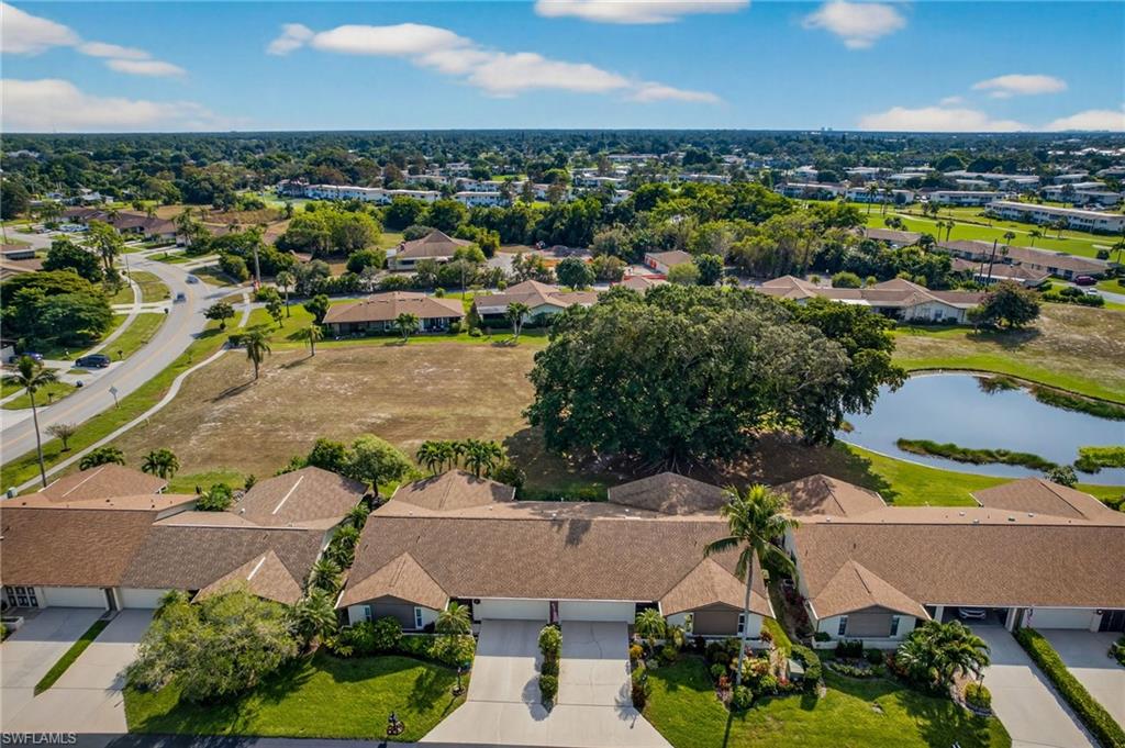 314 Reynolds Court Naples, FL 34112 - Photo 29 of 30 an aerial view of a house with a swimming pool outdoor seating and yard