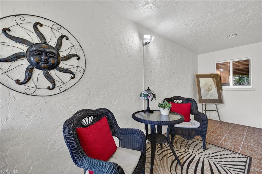 314 Reynolds Court Naples, FL 34112 - Photo 3 of 30 a view of a dining room with furniture and chandelier
