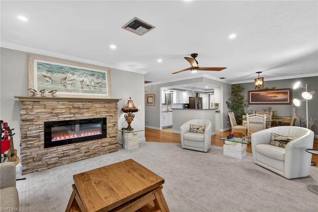 314 Reynolds Court Naples, FL 34112 - Photo 6 of 30 a living room with furniture and a fireplace