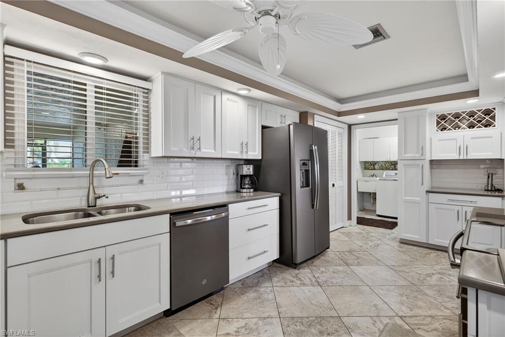 314 Reynolds Court Naples, FL 34112 - Photo 9 of 30 a kitchen with a sink stove and refrigerator