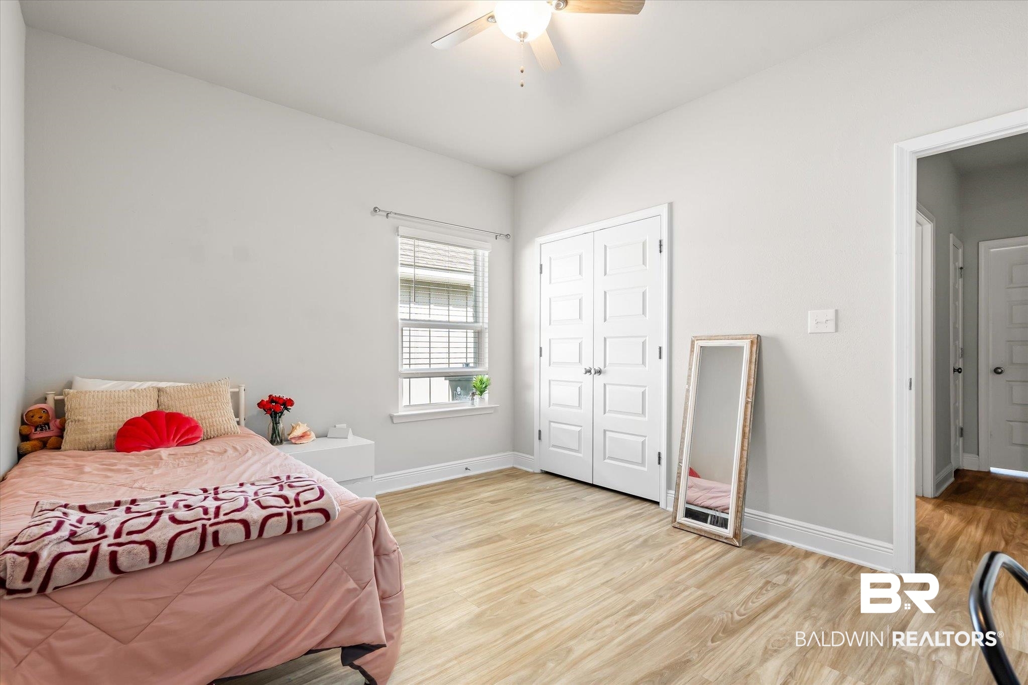 24262 Alydar Loop Daphne, AL 36526 - Photo 11 of 33 Bedroom featuring a closet, ceiling fan, light wood-style flooring, and baseboards