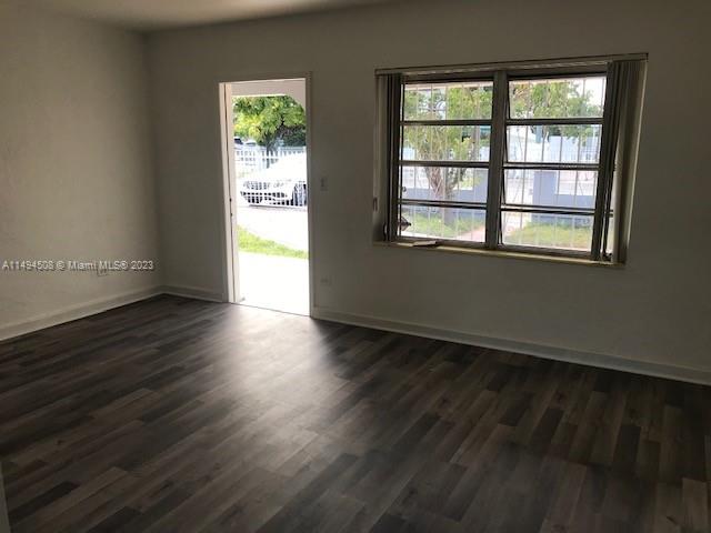 Sun-Tan Village Hialeah, FL 33010 - Photo 3 of 13 an empty room with wooden floor and windows