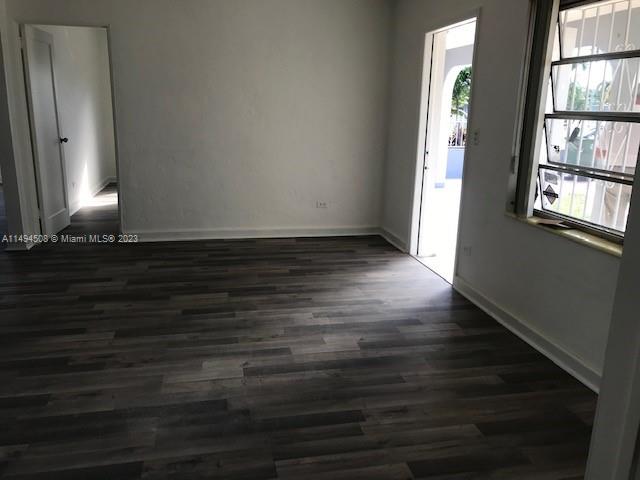 Sun-Tan Village Hialeah, FL 33010 - Photo 4 of 13 a view of an empty room with wooden floor and a window