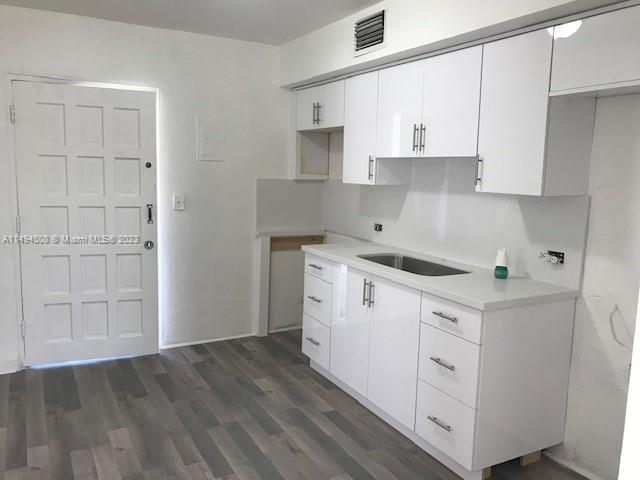 Sun-Tan Village Hialeah, FL 33010 - Photo 5 of 13 a kitchen with white cabinets and white appliances