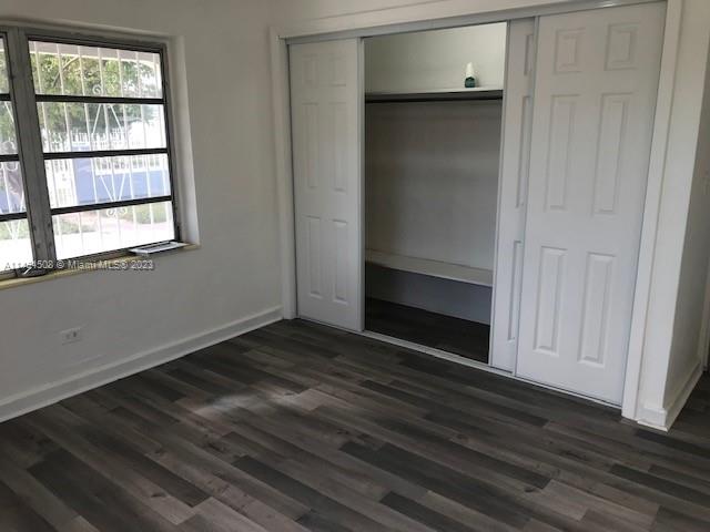 Sun-Tan Village Hialeah, FL 33010 - Photo 6 of 13 an empty room with wooden floor closet and windows