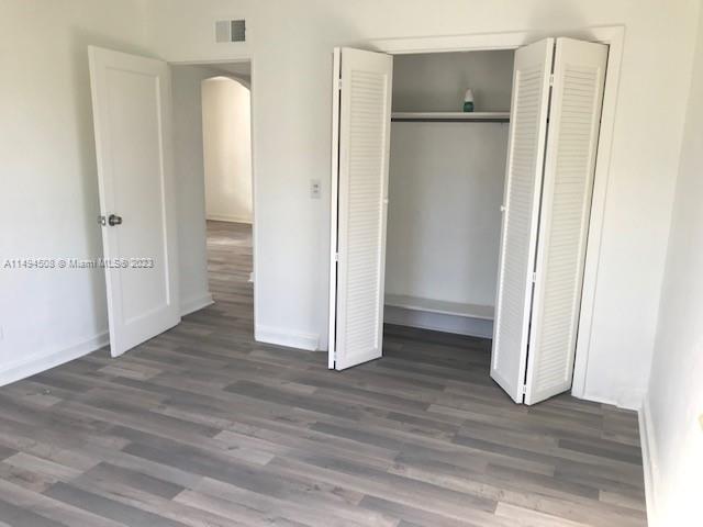 Sun-Tan Village Hialeah, FL 33010 - Photo 7 of 13 a view of an empty room with wooden floor and a bathroom