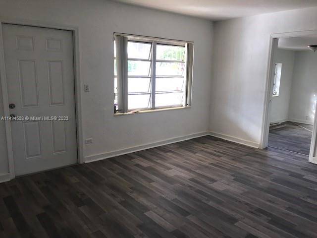 Sun-Tan Village Hialeah, FL 33010 - Photo 8 of 13 an empty room with wooden floor and windows