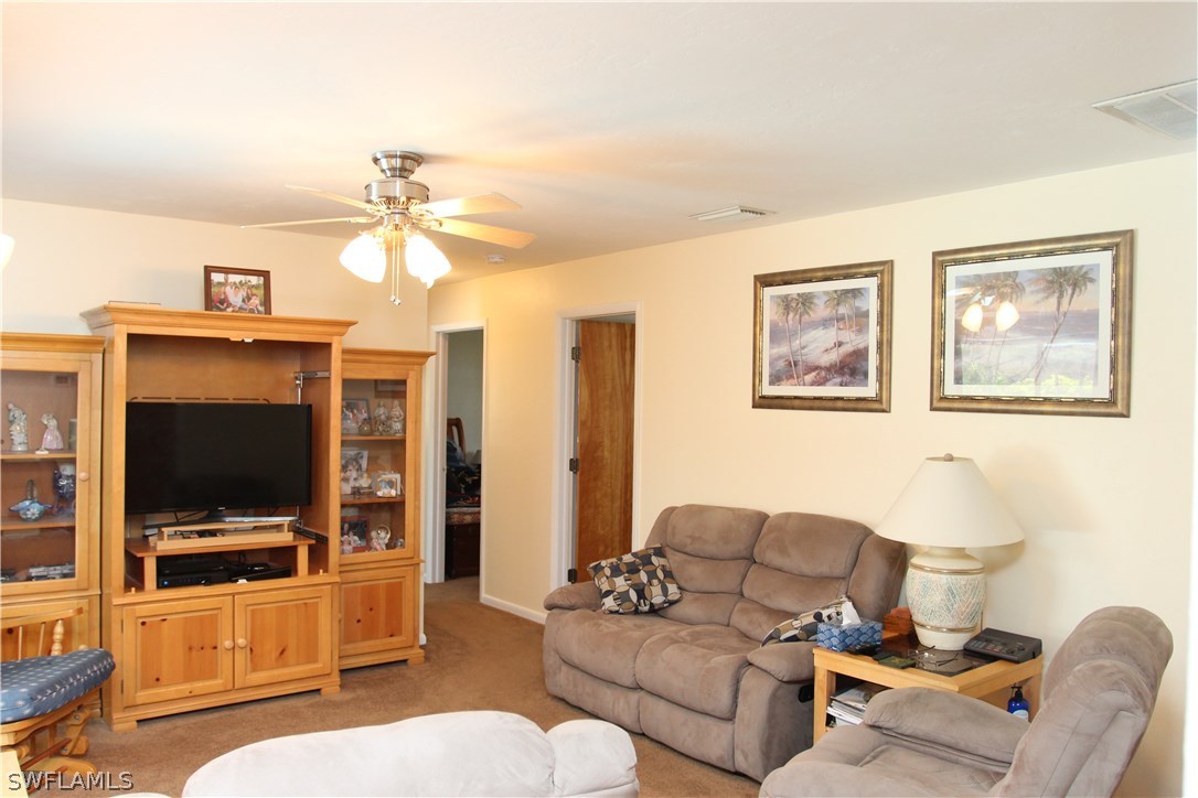 17485 Duquesne Road Fort Myers, FL 33967 - Photo 8 of 25 a living room with furniture and a flat screen tv